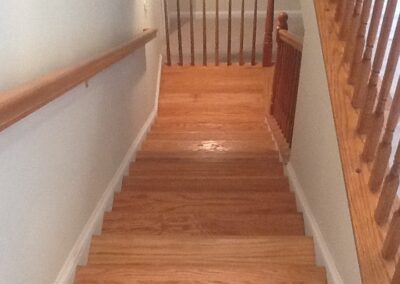 Wooden staircase with banister in a home.